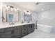 Modern bathroom featuring a double vanity, soaking tub, and elegant fixtures at 6220 E 5Th Ave, Denver, CO 80220