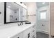 Modern bathroom with a sleek vanity, a large mirror, and a view of the shower at 6220 E 5Th Ave, Denver, CO 80220
