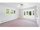 Sunlit bedroom with a bay window providing scenic views, carpeted floor, and neutral colors at 6220 E 5Th Ave, Denver, CO 80220