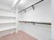 Bright, walk-in closet with ample shelving and hanging space, perfect for organization at 6220 E 5Th Ave, Denver, CO 80220