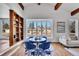 Bright dining area features a bay window, hardwood floors, and a custom bookshelf at 6220 E 5Th Ave, Denver, CO 80220