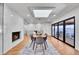 Modern dining room with fireplace and glass doors leading to patio at 6220 E 5Th Ave, Denver, CO 80220