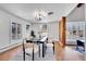 Bright dining room with hardwood floors, modern lighting, and bay windows providing natural light at 6220 E 5Th Ave, Denver, CO 80220