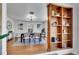 Dining room features a modern chandelier, artwork, and built-in bookcase at 6220 E 5Th Ave, Denver, CO 80220