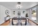 Chic dining room featuring a stylish chandelier, modern art, and a large window for ample natural light at 6220 E 5Th Ave, Denver, CO 80220