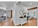Inviting entryway with hardwood floors, console table and decor, leading into the living and dining areas at 6220 E 5Th Ave, Denver, CO 80220