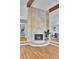 Modern fireplace with stone surround and hardwood floors, seamlessly connecting dining and living areas at 6220 E 5Th Ave, Denver, CO 80220