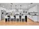 Bright kitchen with white cabinetry, stainless steel appliances and a large island with seating at 6220 E 5Th Ave, Denver, CO 80220