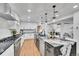 Well-equipped kitchen featuring stainless appliances, updated lighting and a large island at 6220 E 5Th Ave, Denver, CO 80220