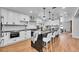 Modern kitchen with stainless steel appliances, quartz countertops and island with breakfast bar at 6220 E 5Th Ave, Denver, CO 80220