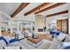 Expansive living area featuring a modern fireplace, open layout, and seamless flow between the living, dining, and kitchen spaces at 6220 E 5Th Ave, Denver, CO 80220