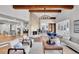 Spacious living room with a central fireplace, open layout, and a cohesive design that connects the various living spaces within the home at 6220 E 5Th Ave, Denver, CO 80220