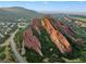 Aerial view of dramatic rock formations and residential homes in a valley at 6338 Spotted Fawn Run, Littleton, CO 80125