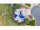 Aerial view of home with solar panels, lush landscaping, circular driveway, and an outdoor patio area at 6338 Spotted Fawn Run, Littleton, CO 80125