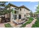 Backyard featuring fire pit area and lush landscaping adjacent to a modern home exterior at 6338 Spotted Fawn Run, Littleton, CO 80125