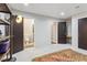 Large finished basement showing multiple doorways, storage area, and a colorful rug at 6338 Spotted Fawn Run, Littleton, CO 80125