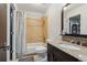 Modern bathroom featuring granite countertop vanity and tiled shower and bathtub combination at 6338 Spotted Fawn Run, Littleton, CO 80125