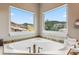 Corner soaking tub with a beautiful view at 6338 Spotted Fawn Run, Littleton, CO 80125