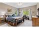 Bedroom with a ceiling fan, cozy bed, and natural light from the windows at 6338 Spotted Fawn Run, Littleton, CO 80125
