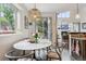 Cozy breakfast nook with a marble table, stylish chairs, and pendant lighting next to sliding glass doors at 6338 Spotted Fawn Run, Littleton, CO 80125