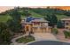 Beautiful stucco home with a three car garage, tile roof and solar panels nestled in a hillside community at 6338 Spotted Fawn Run, Littleton, CO 80125