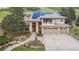 Beautiful two-story home featuring manicured landscaping, a three-car garage, and a covered front entrance at 6338 Spotted Fawn Run, Littleton, CO 80125
