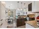 Modern kitchen with granite countertops, stainless steel appliances, kitchen island with gas cooktop and breakfast nook at 6338 Spotted Fawn Run, Littleton, CO 80125