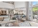 Open concept living room and kitchen area with natural light, wood floors, and modern decor at 6338 Spotted Fawn Run, Littleton, CO 80125