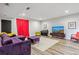 Contemporary living room with purple sofa, piano, and large screen television at 6338 Spotted Fawn Run, Littleton, CO 80125