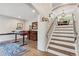 Home office with built-in desk, wood floors, modern lighting and stair access to upper level at 6338 Spotted Fawn Run, Littleton, CO 80125