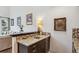 Elegant wet bar featuring granite countertops, cabinetry, and decorative backsplash at 6338 Spotted Fawn Run, Littleton, CO 80125