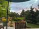 Landscaped backyard patio featuring beautiful sunset views, outdoor seating, and lush garden at 7202 Snow Peak Ct, Niwot, CO 80503