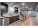 Basement wet bar and stairs leading to another room with lounge seating at 7202 Snow Peak Ct, Niwot, CO 80503