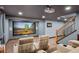 Home theater room with comfortable seating, a large screen, and a staircase at 7202 Snow Peak Ct, Niwot, CO 80503