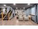 Finished basement with wood flooring, a staircase and leather theater chairs at 7202 Snow Peak Ct, Niwot, CO 80503