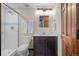 Bathroom featuring a walk-in shower, and a dark brown vanity with a white countertop sink at 7202 Snow Peak Ct, Niwot, CO 80503