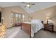 Inviting bedroom features a large bay window, wood furniture, plush carpet, and a ceiling fan at 7202 Snow Peak Ct, Niwot, CO 80503