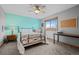 This bedroom features a ceiling fan, a window with a view, and a black wrought iron bed frame at 7202 Snow Peak Ct, Niwot, CO 80503
