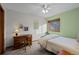This bedroom has neutral colored carpet, green walls, and a ceiling fan at 7202 Snow Peak Ct, Niwot, CO 80503