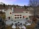 Dusk aerial of the back of the house, patio with fire pit, and outdoor seating at 7202 Snow Peak Ct, Niwot, CO 80503