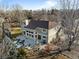 Aerial view of the house showcasing the backyard, patio area, mature trees, and landscaping at 7202 Snow Peak Ct, Niwot, CO 80503