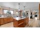 Spacious kitchen features wood cabinets, granite counters, stainless sink, and a view to the backyard at 7202 Snow Peak Ct, Niwot, CO 80503