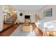 Inviting living room with hardwood floors, staircase, and large windows that fill the space with natural light at 7202 Snow Peak Ct, Niwot, CO 80503