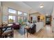 Spacious living room with a vaulted ceiling, brick fireplace, large windows, and hardwood floors, perfect for relaxing at 7202 Snow Peak Ct, Niwot, CO 80503