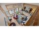 Aerial view of a cozy living room with fireplace, large windows, hardwood floors, and comfortable seating at 7202 Snow Peak Ct, Niwot, CO 80503