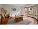 Bright living room with hardwood floors, large windows, and stylish furniture, creating a warm and inviting atmosphere at 7202 Snow Peak Ct, Niwot, CO 80503