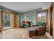 Cozy office with a desk, chair, armchair, and sliding doors to the outside creates a tranquil workspace at 7202 Snow Peak Ct, Niwot, CO 80503
