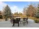 Cozy outdoor patio with a stone fire pit surrounded by comfortable seating, perfect for gatherings at 7202 Snow Peak Ct, Niwot, CO 80503