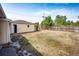 Fenced backyard with lots of yard space and a storage building at 3125 W Ford Pl, Denver, CO 80219