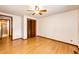 Bedroom with ceiling fan, closet, and light wood-look laminate flooring at 3125 W Ford Pl, Denver, CO 80219